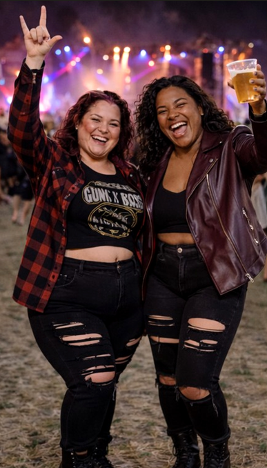 Two women wearing black jeans and leather jackets, immersed in the excitement of a music festival atmosphere.