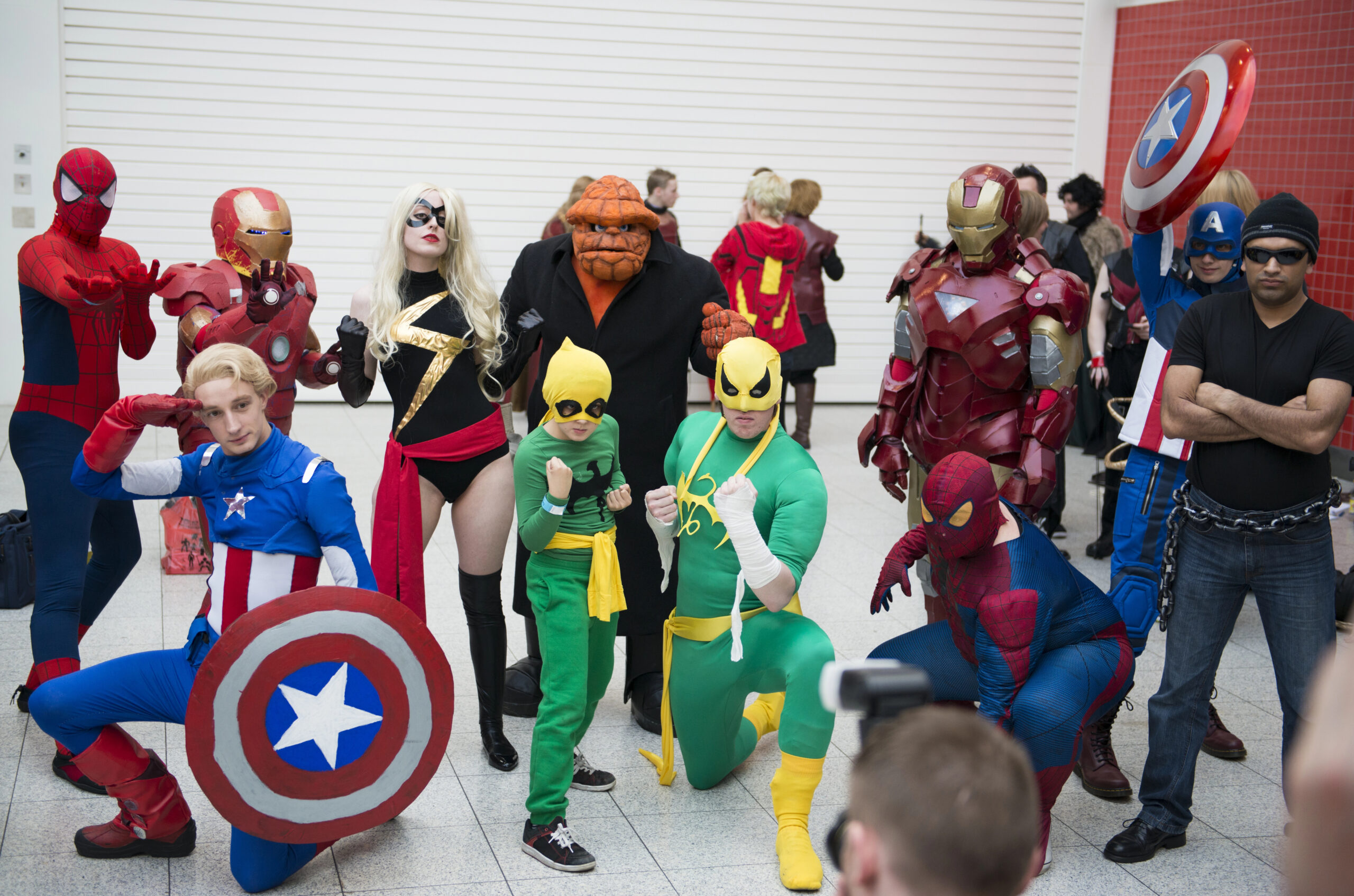 A group of cosplayers enjoying a fun photo at a comic convention