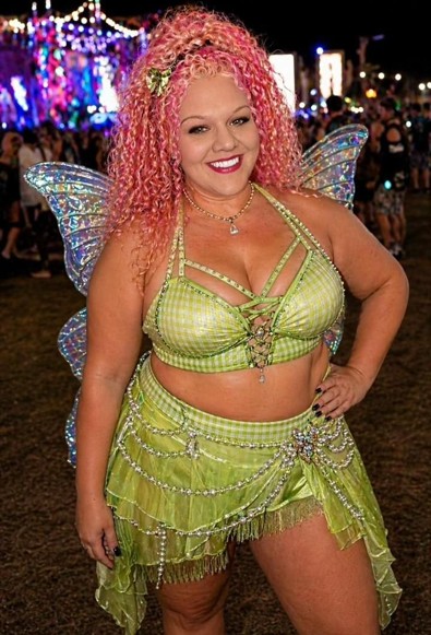 Woman in fairy costume with wings at a music festival