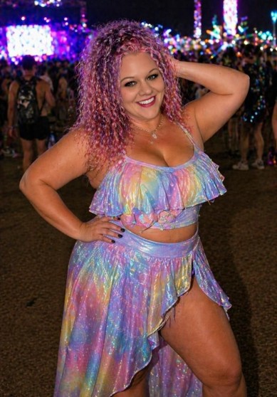 Woman in colorful rainbow sparkling festival outfit