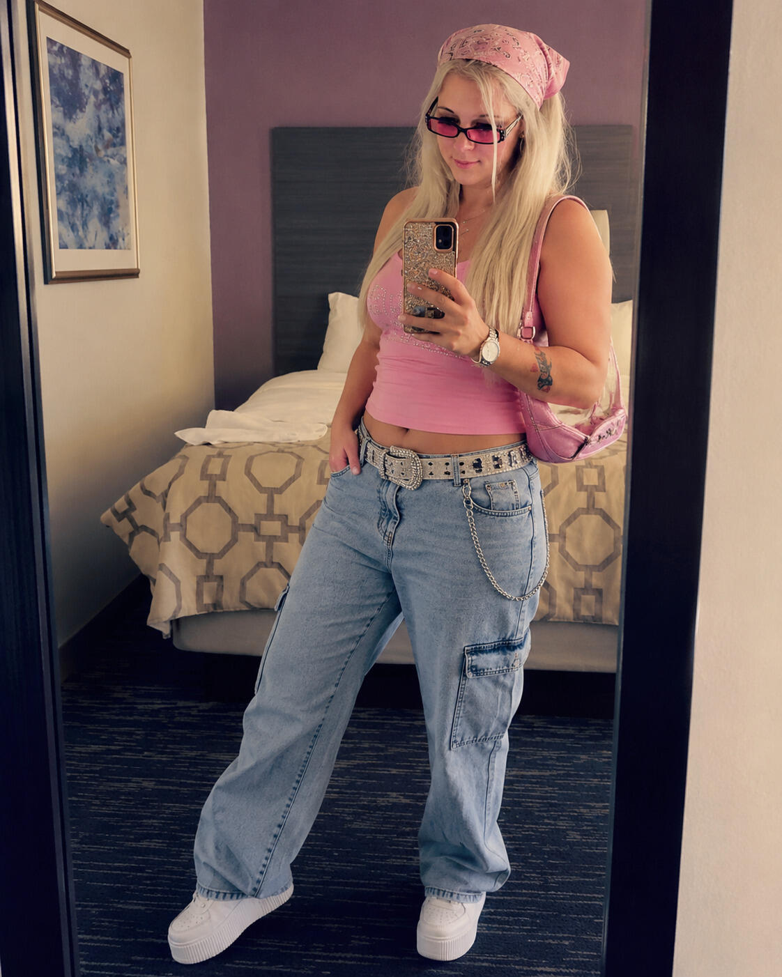 Woman in a motel room posing in a Y2K outfit.