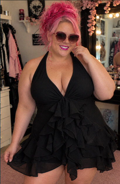 Woman in black ruffle swimdress.