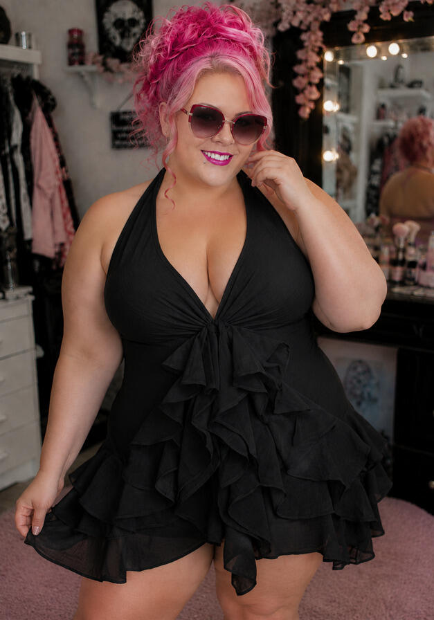 Woman in black ruffle swimdress.
